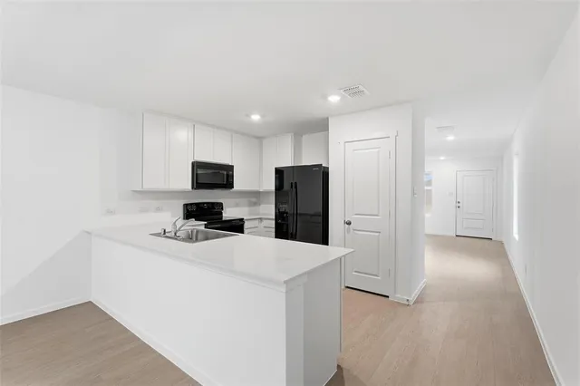 a kitchen with a sink and refrigerator