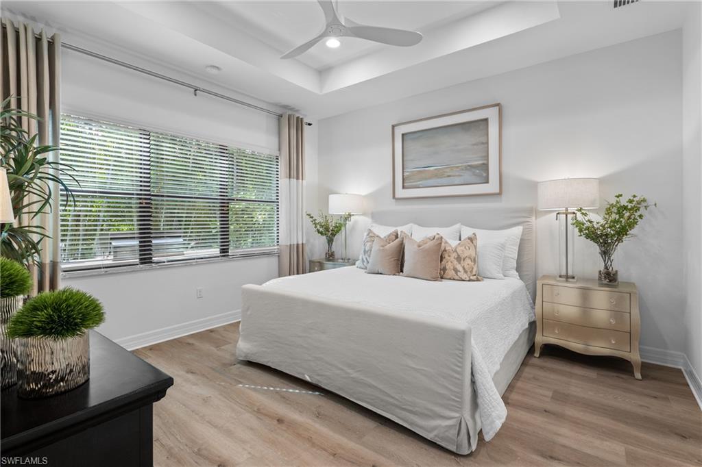 13459 Sumter Lane Naples, FL 34109 - Photo 12 of 40 a bedroom with a large bed and a potted plant