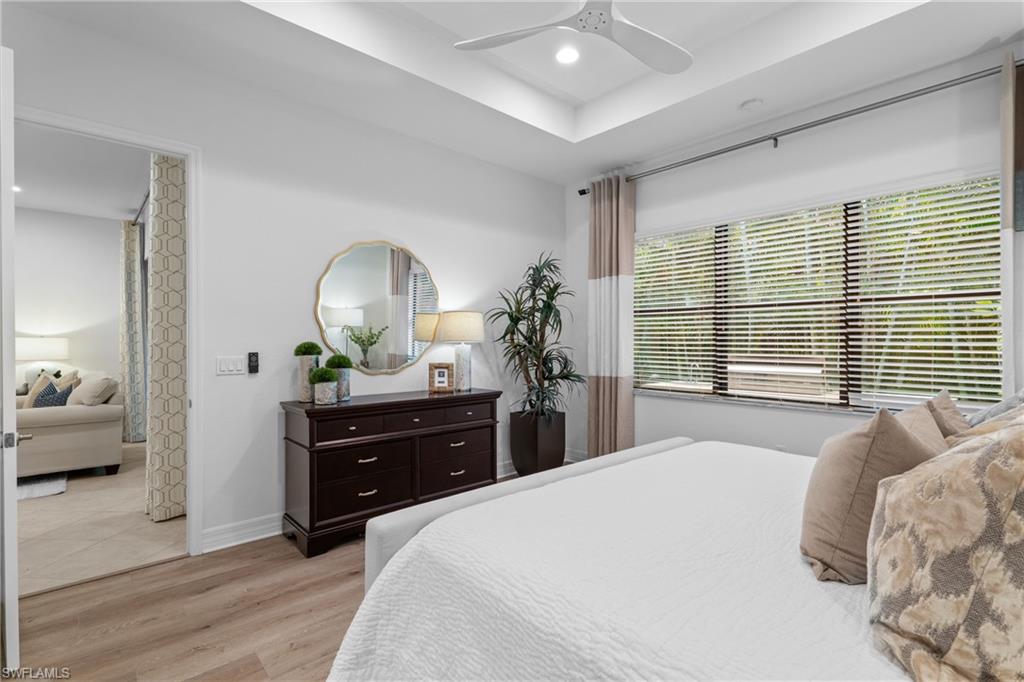 13459 Sumter Lane Naples, FL 34109 - Photo 13 of 40 a bedroom with a bed and a dresser
