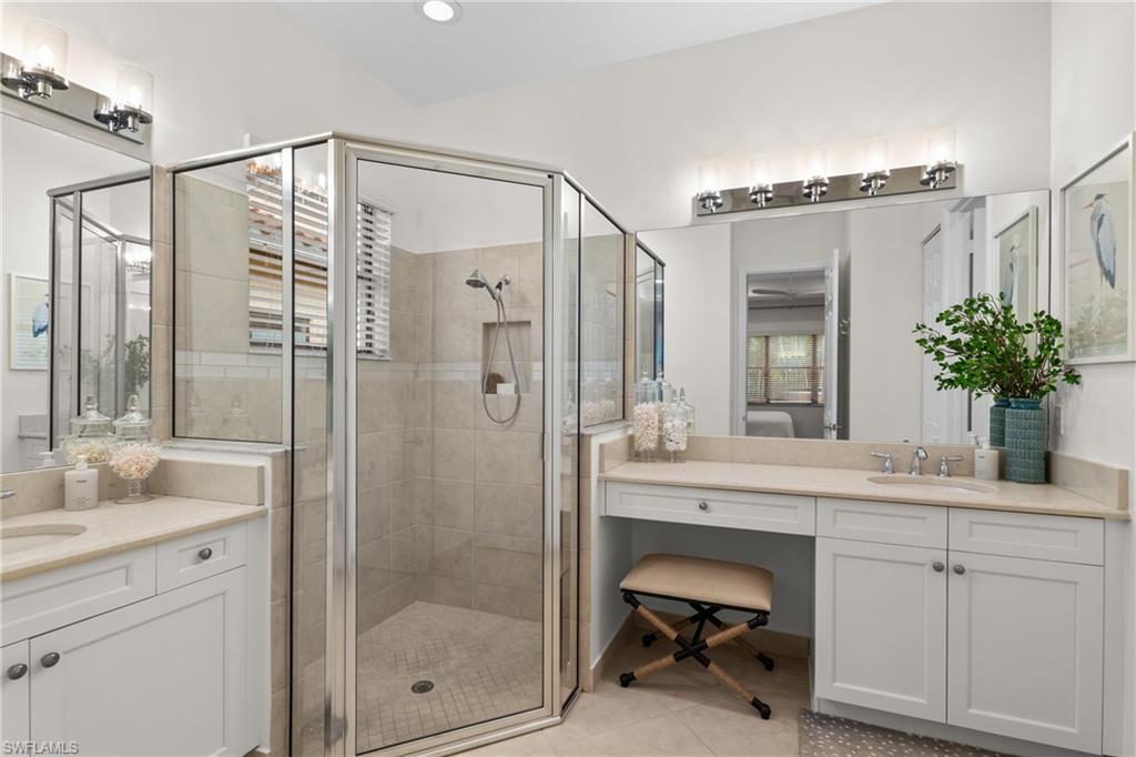 13459 Sumter Lane Naples, FL 34109 - Photo 14 of 40 a bathroom with a shower sink and mirror