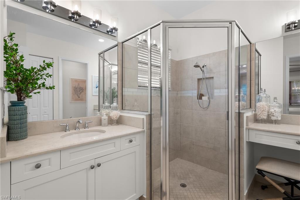 13459 Sumter Lane Naples, FL 34109 - Photo 15 of 40 a bathroom with a shower sink and mirror