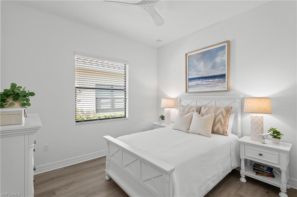 13459 Sumter Lane Naples, FL 34109 - Photo 17 of 40 a bedroom with a bed and a window