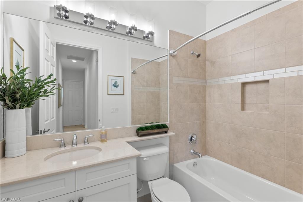 13459 Sumter Lane Naples, FL 34109 - Photo 18 of 40 a bathroom with a granite countertop sink mirror and a bathtub