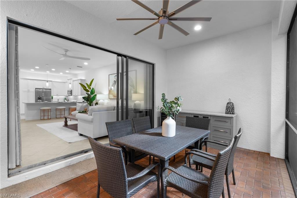 13459 Sumter Lane Naples, FL 34109 - Photo 21 of 40 a dining room with furniture potted plants and wooden floor