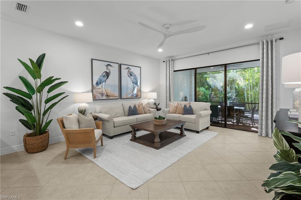 13459 Sumter Lane Naples, FL 34109 - Photo 3 of 40 a living room with furniture a large window and a potted plant