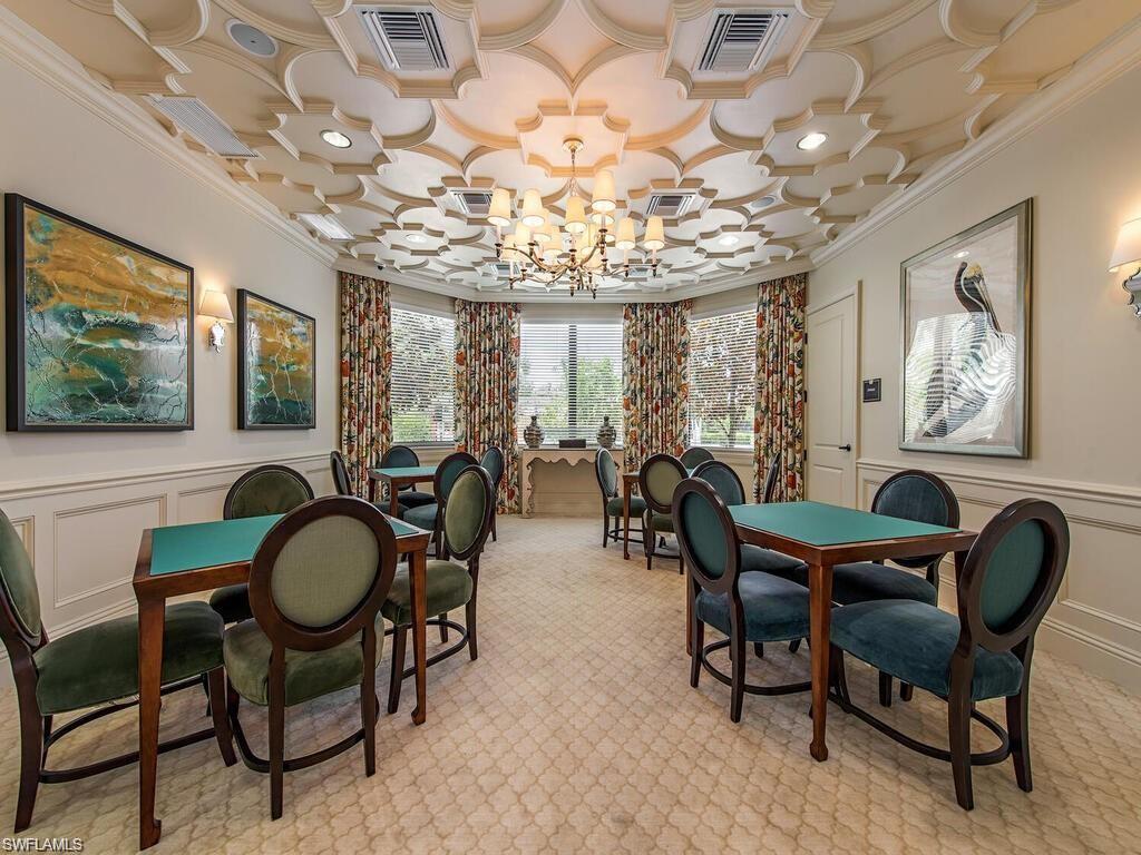 13459 Sumter Lane Naples, FL 34109 - Photo 32 of 40 a view of a dining room with furniture a chandelier and large windows