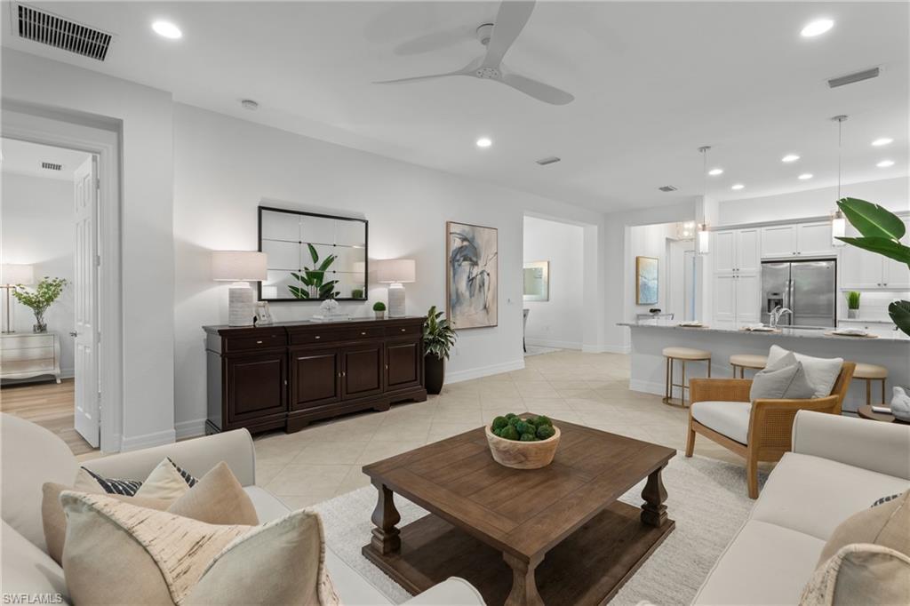 13459 Sumter Lane Naples, FL 34109 - Photo 5 of 40 a living room with furniture and a wooden table