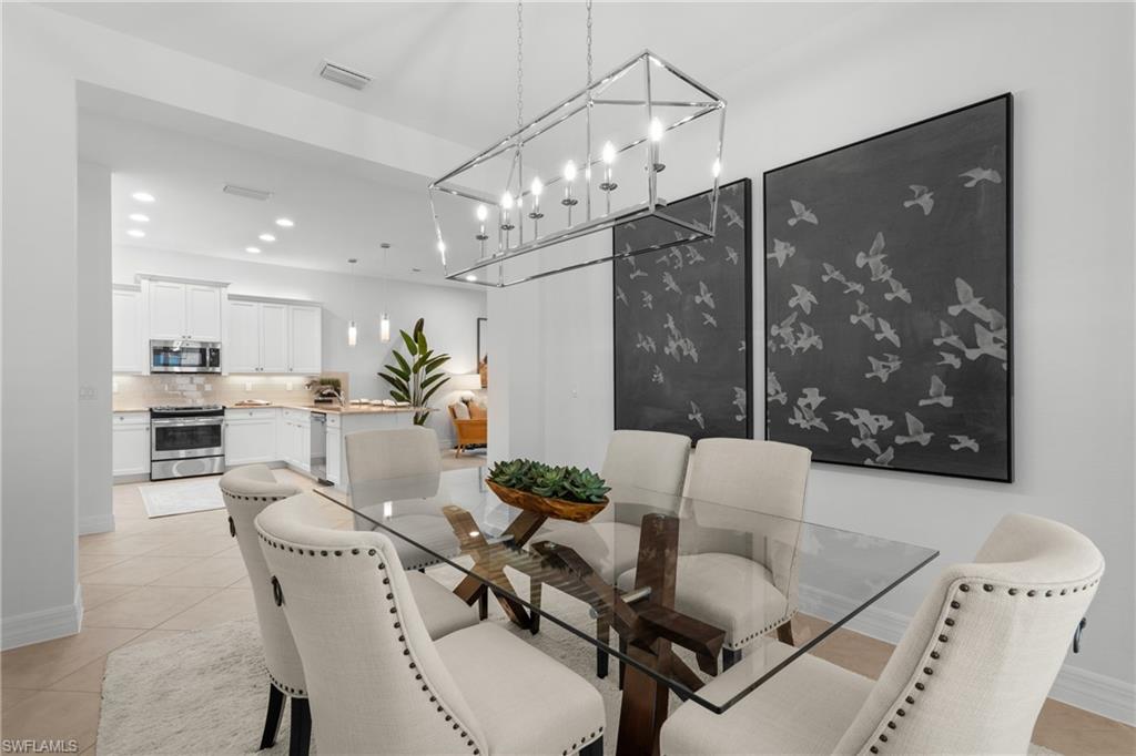 13459 Sumter Lane Naples, FL 34109 - Photo 10 of 40 a view of a dining room with furniture and chandelier