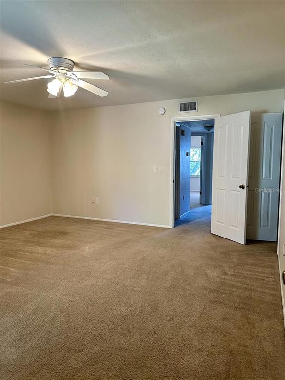 501 Southwest 75th Street, Unit G1 Gainesville, FL 32607 - Photo 13 of 20 a view of an empty room with a chandelier fan