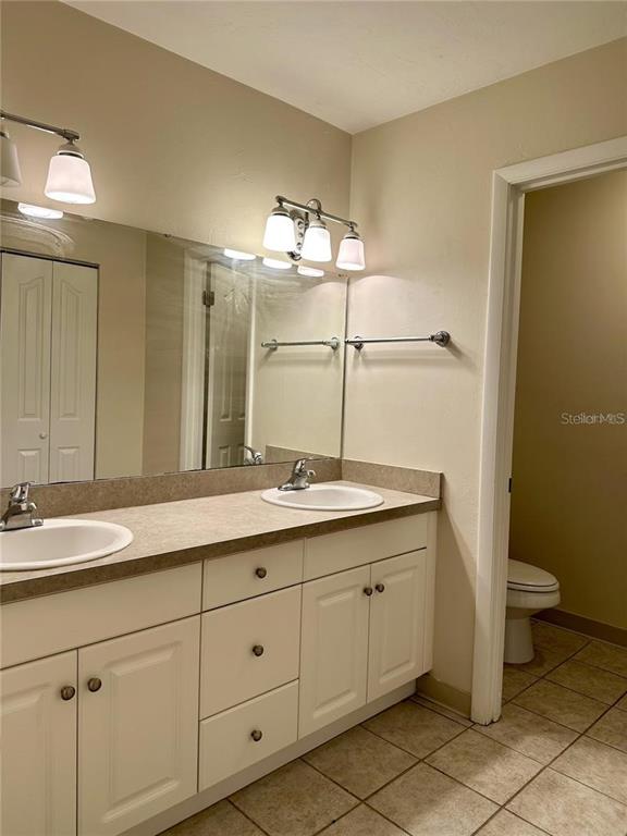 501 Southwest 75th Street, Unit G1 Gainesville, FL 32607 - Photo 15 of 20 a bathroom with a double vanity sink and a mirror