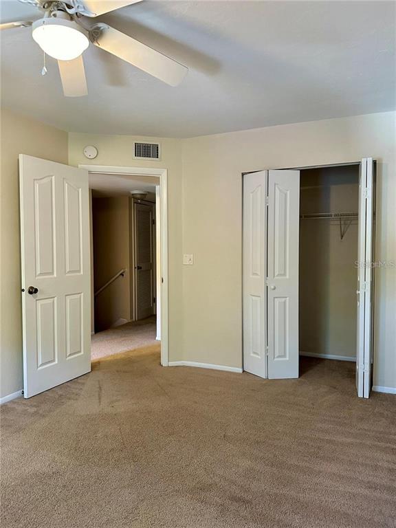 501 Southwest 75th Street, Unit G1 Gainesville, FL 32607 - Photo 19 of 20 an empty room with closet and a chandelier fan
