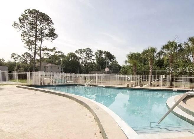 501 Southwest 75th Street, Unit G1 Gainesville, FL 32607 - Photo 20 of 20 a view of a swimming pool with a yard and lake view