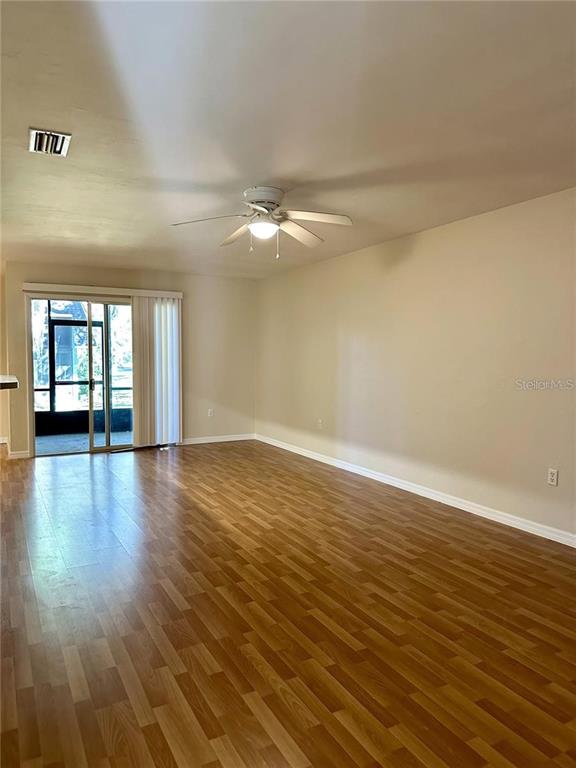501 Southwest 75th Street, Unit G1 Gainesville, FL 32607 - Photo 8 of 20 wooden floor in an empty room with a window