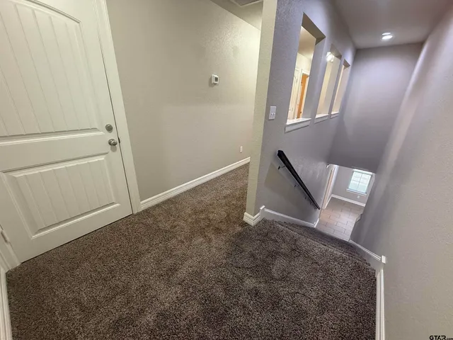 a bathroom with a granite countertop sink a toilet a mirror and bathtub