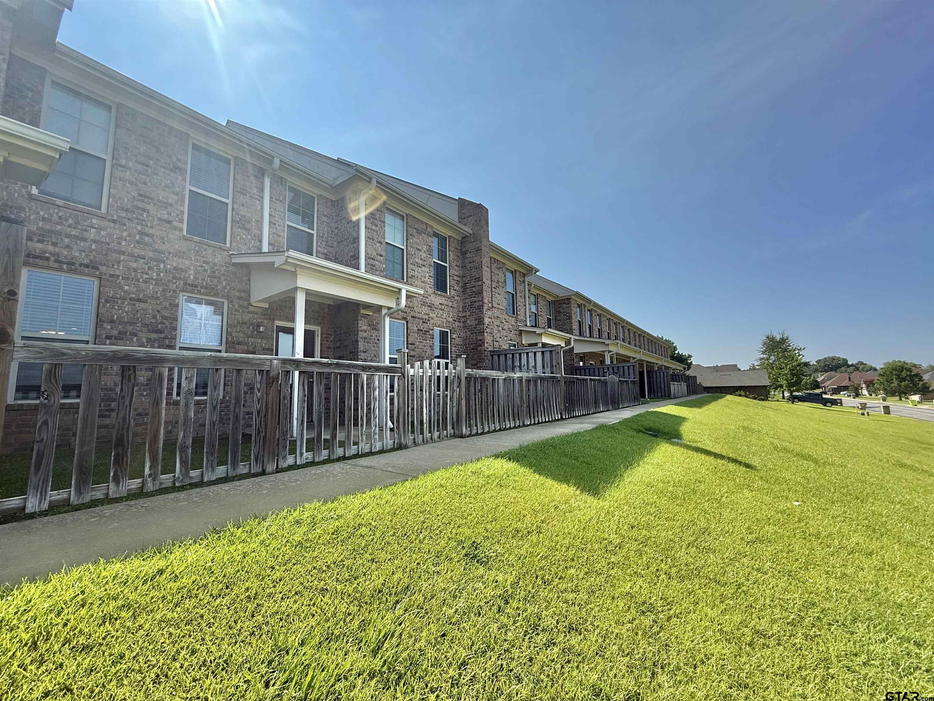 16440 County Road 178, Unit 1007 Tyler, TX 75703 - Photo 2 of 25 a view of an house with backyard and swimming pool