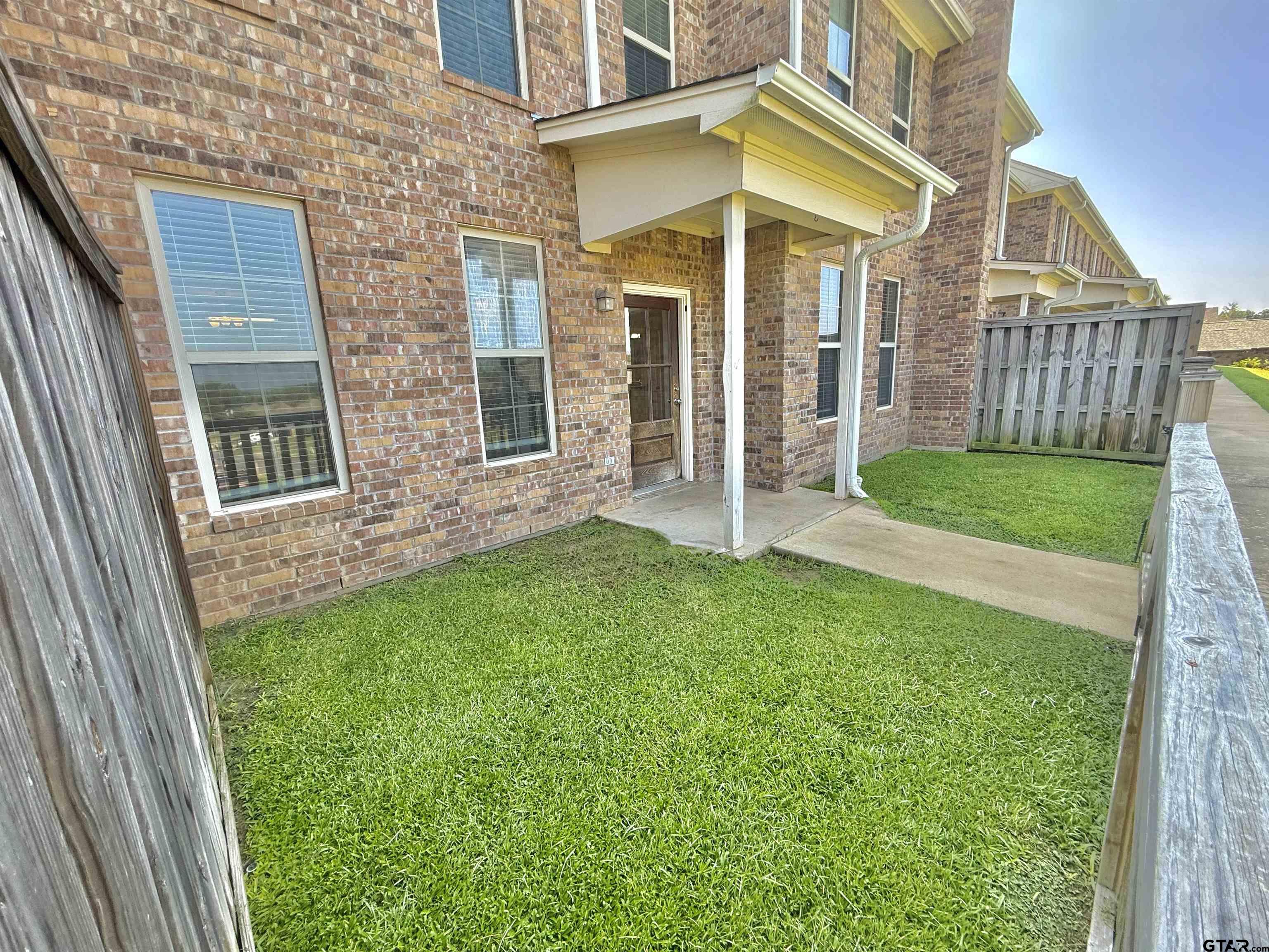 16440 County Road 178, Unit 1007 Tyler, TX 75703 - Photo 25 of 25 a view of a house with a yard and wooden fence