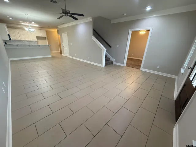 an empty room with an entrance and mirror