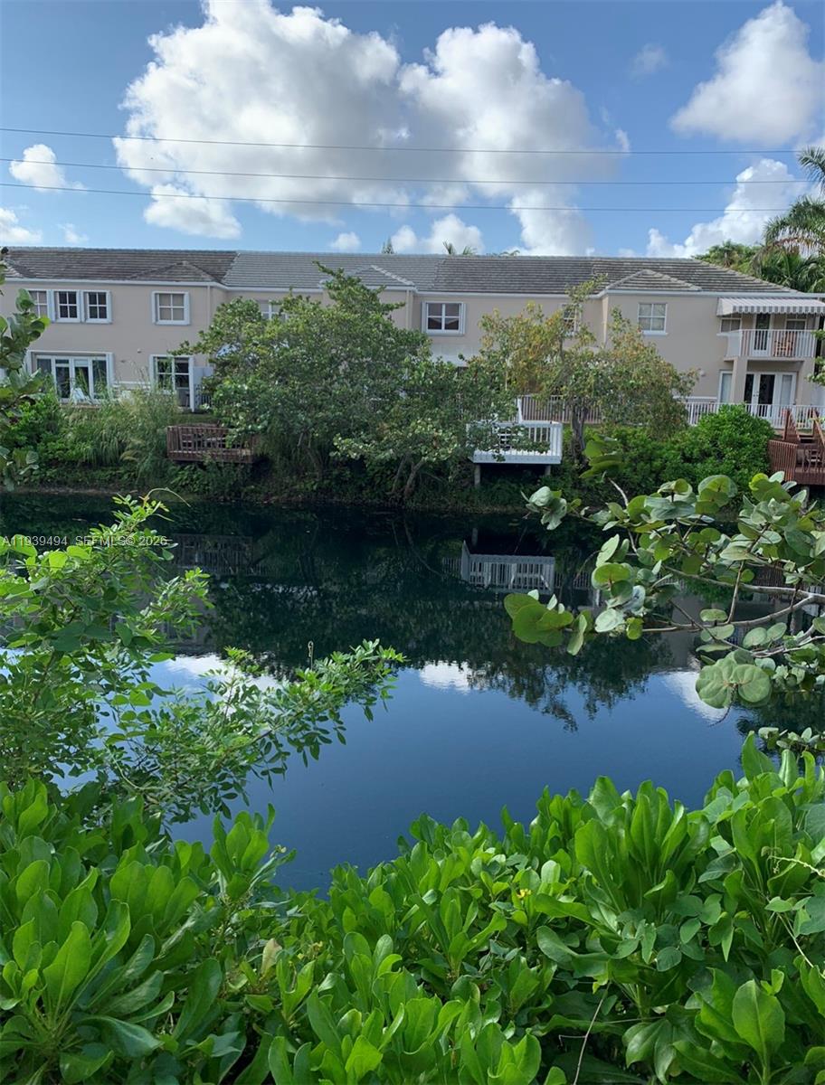 6950 Southwest 55th Terrace East Miami, FL 33155 - Photo 15 of 16 a view of a lake with a house in the background