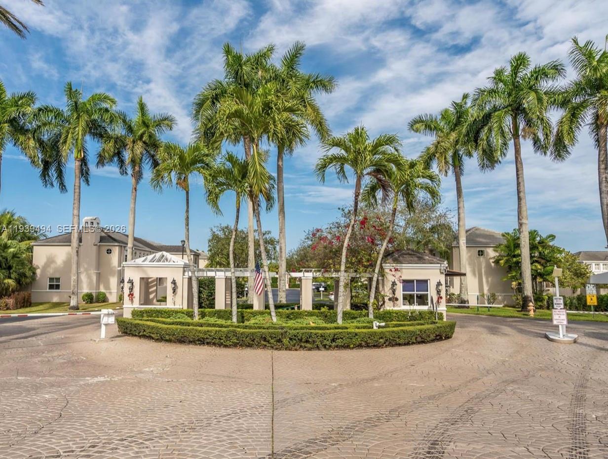 6950 Southwest 55th Terrace East Miami, FL 33155 - Photo 2 of 16 a view of a white house with a large trees and plants