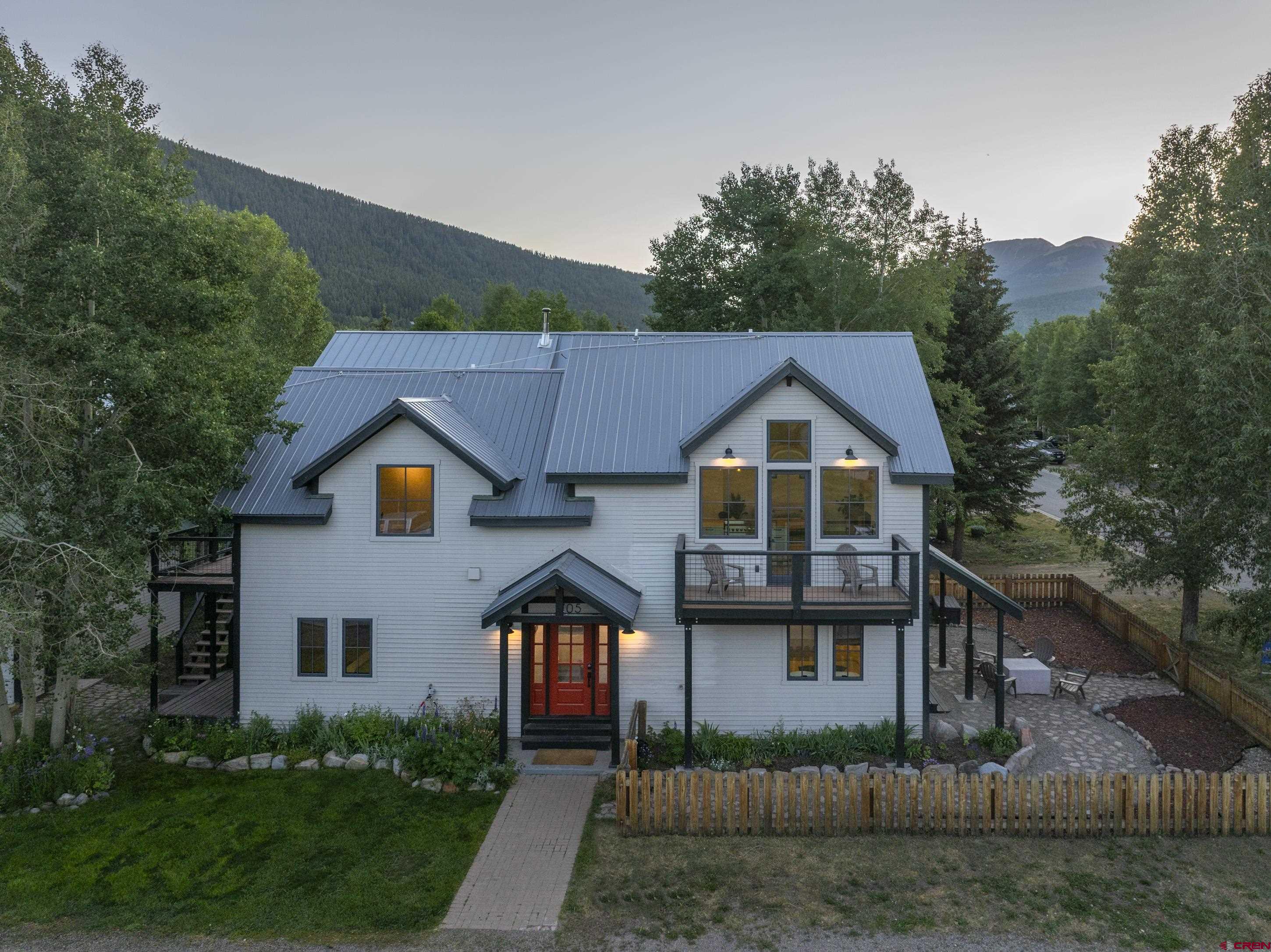 705 9th Street Crested Butte, CO 81224 - Photo 12 of 44 a house with trees in the background