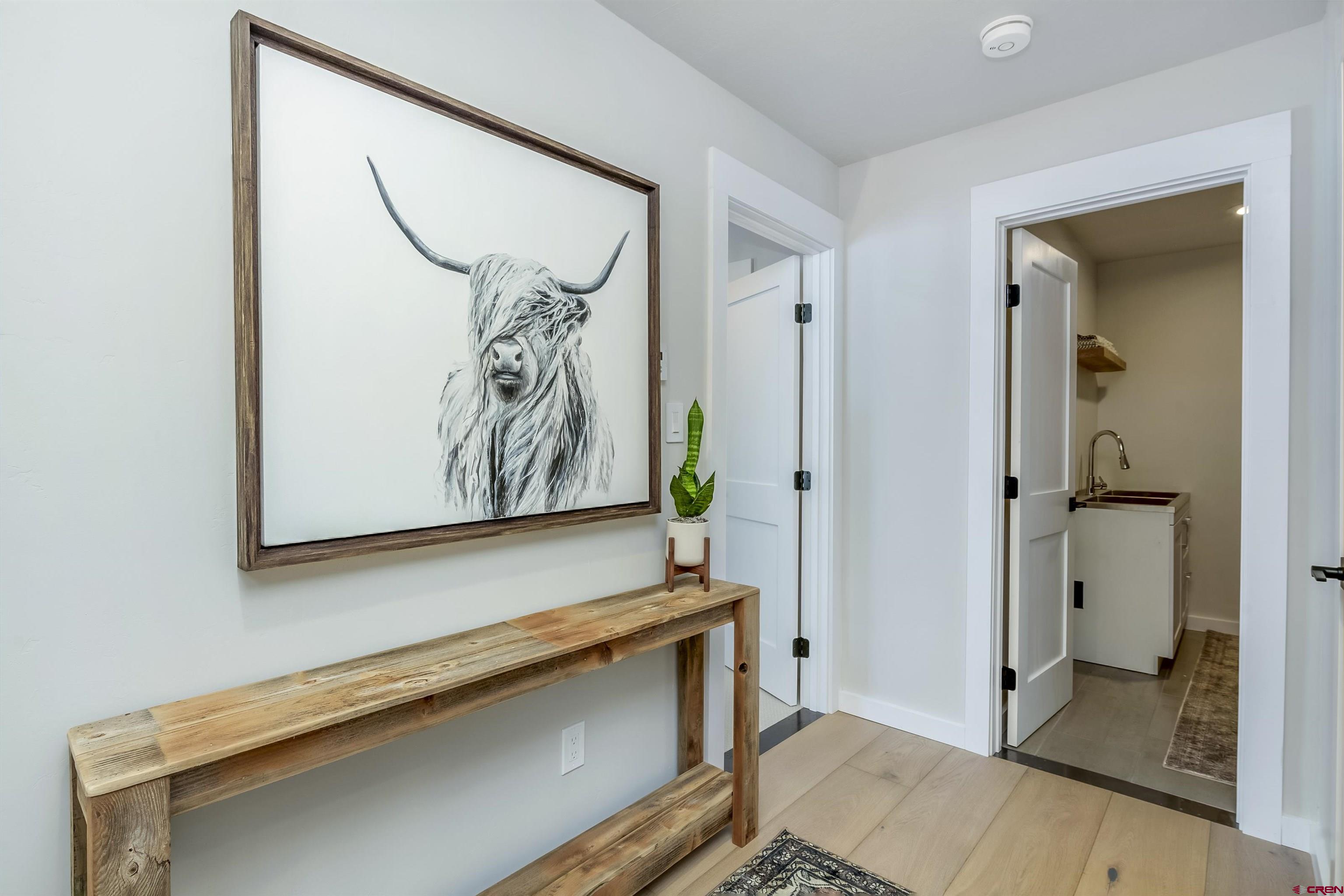 705 9th Street Crested Butte, CO 81224 - Photo 22 of 44 a view of a hallway with paintings on the wall
