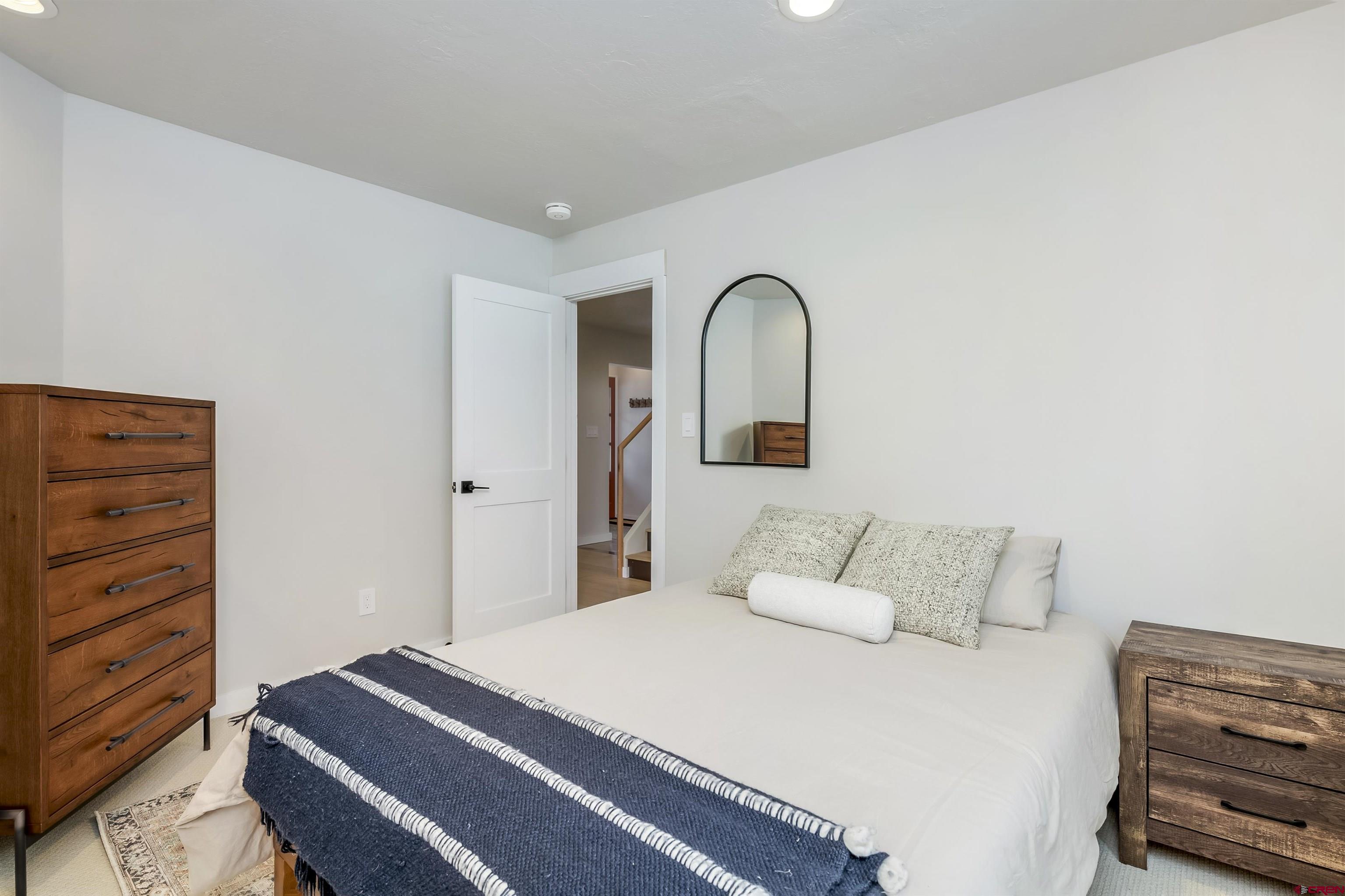 705 9th Street Crested Butte, CO 81224 - Photo 24 of 44 a bedroom with a bed and a dresser