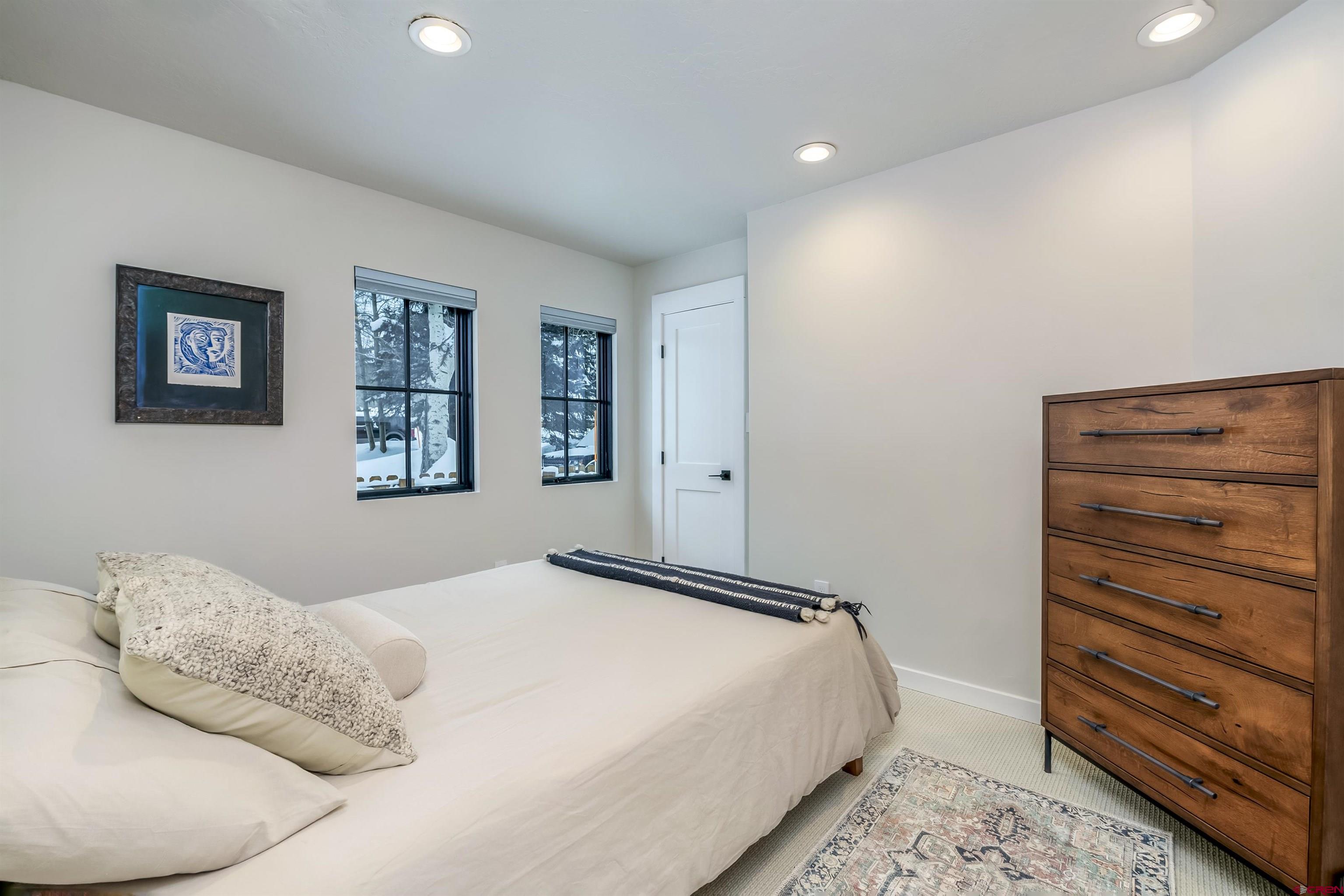 705 9th Street Crested Butte, CO 81224 - Photo 25 of 44 a bedroom with a bed and a window
