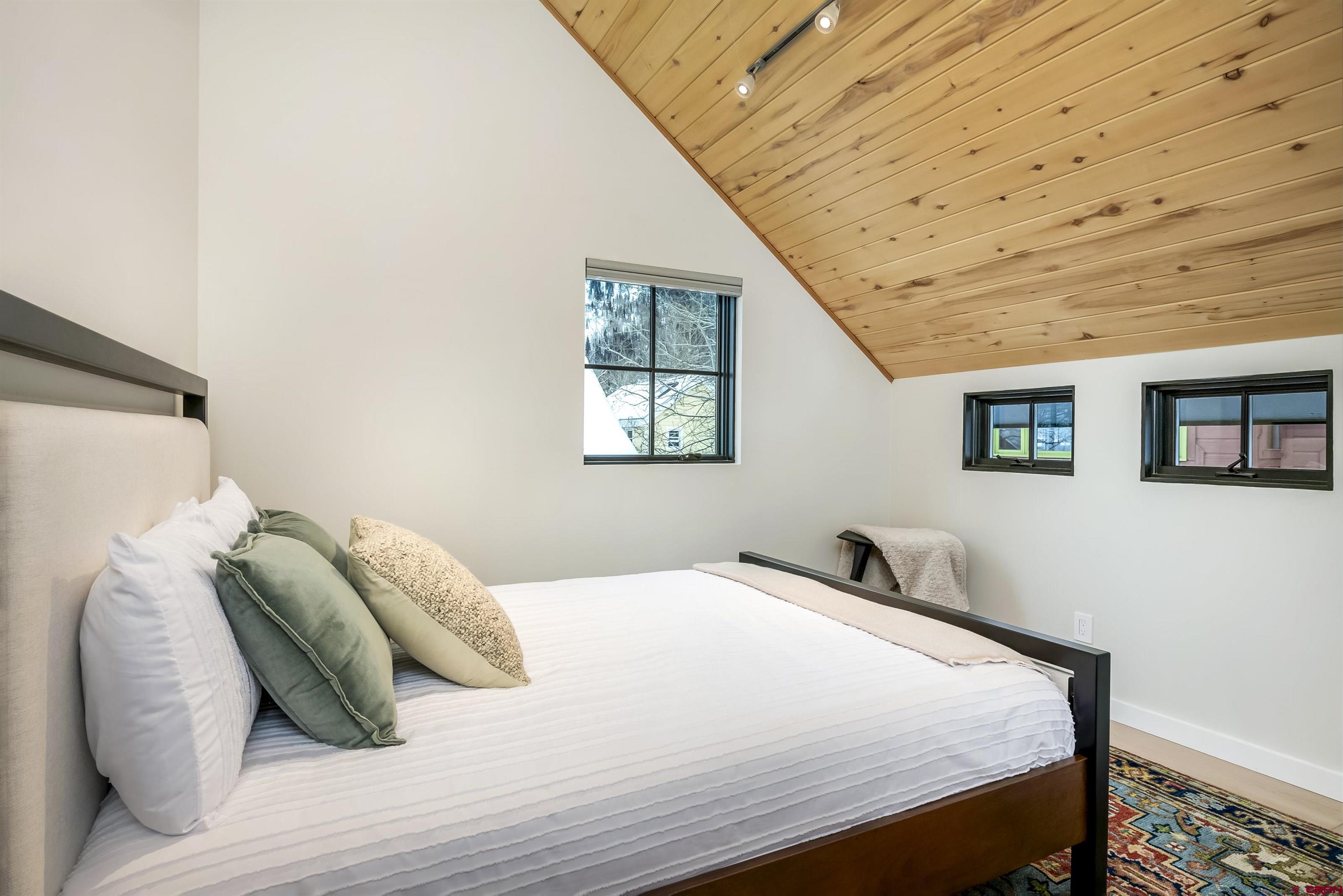 705 9th Street Crested Butte, CO 81224 - Photo 40 of 44 a bedroom with a bed and a window