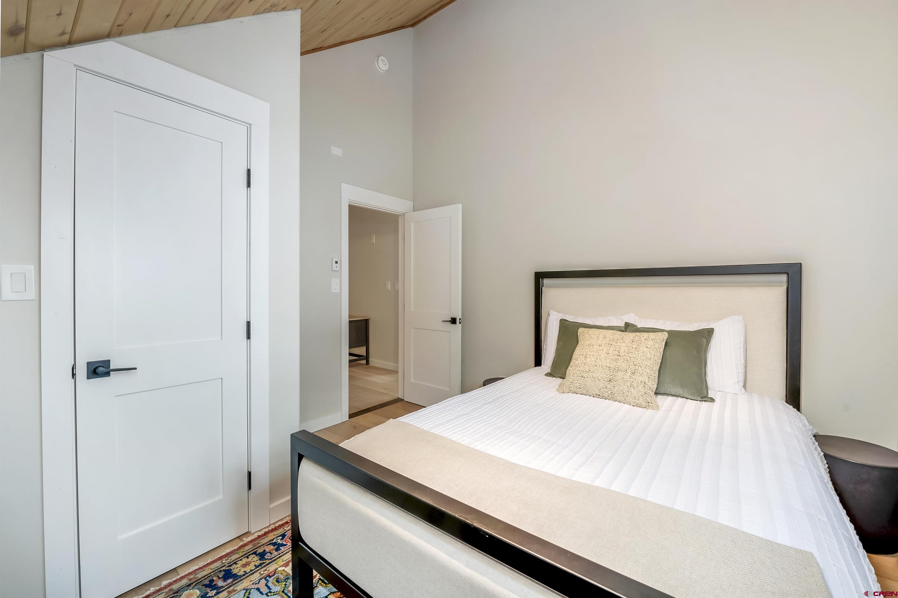 705 9th Street Crested Butte, CO 81224 - Photo 41 of 44 a bedroom with a bed and a mirror