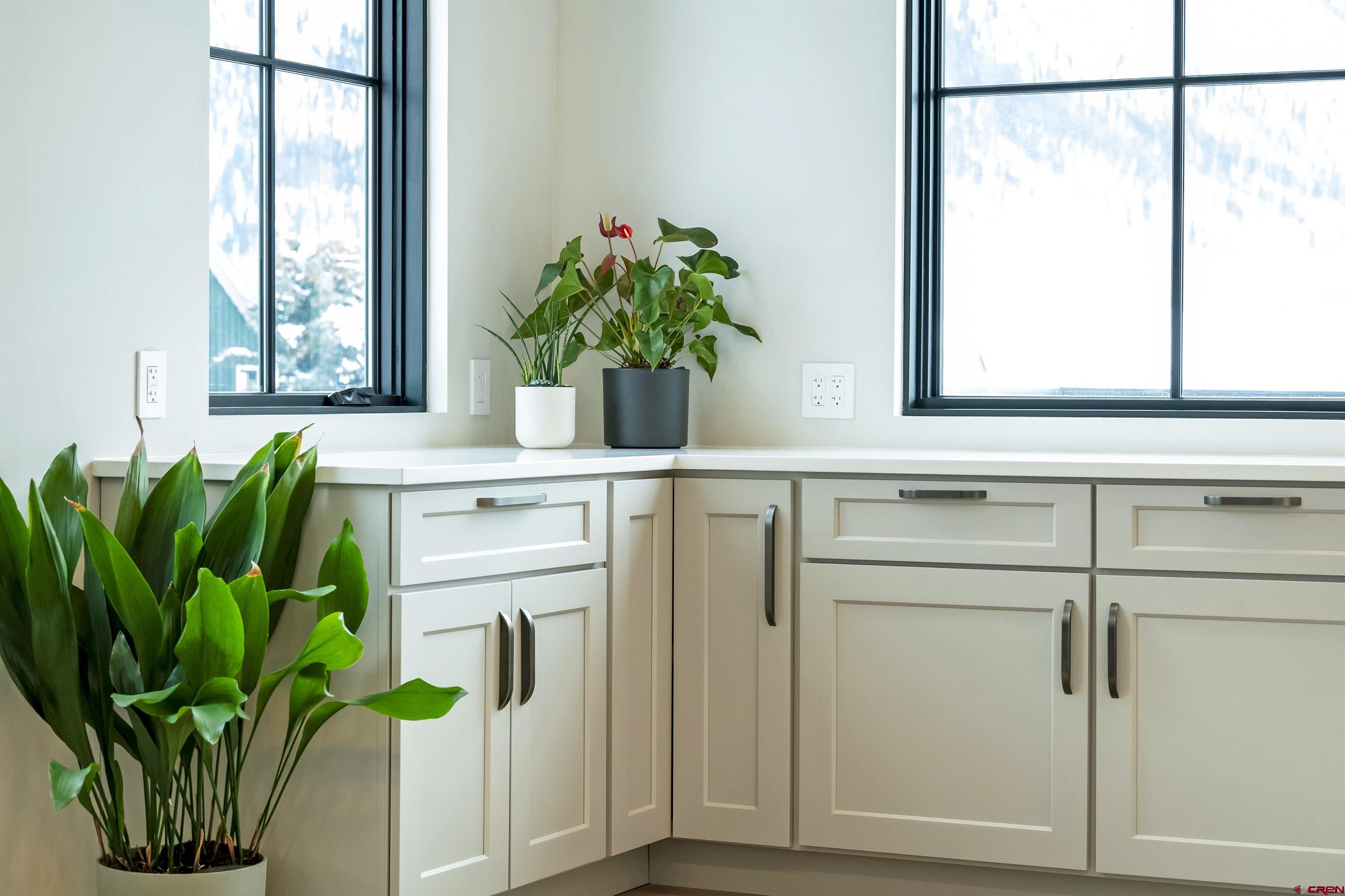 705 9th Street Crested Butte, CO 81224 - Photo 7 of 44 a white vase with white and yellow flowers