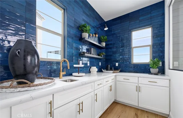 a kitchen with sink and cabinets