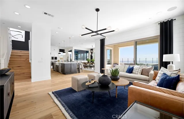 a living room with furniture fireplace and a large window