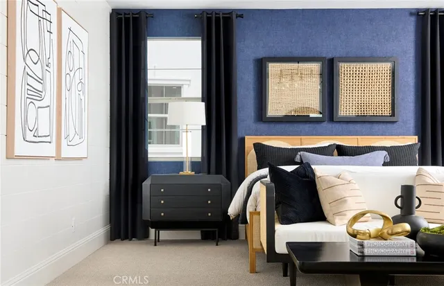 a bedroom with a bed and windows