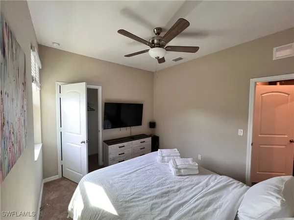 a bedroom with a bed and a flat screen tv