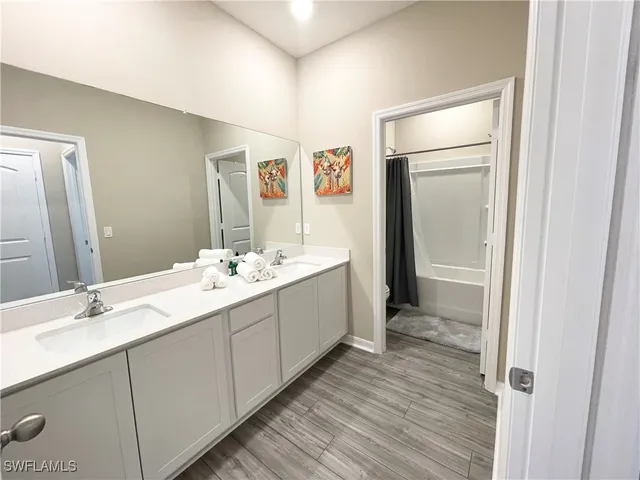 a bathroom with a double vanity sink and mirror