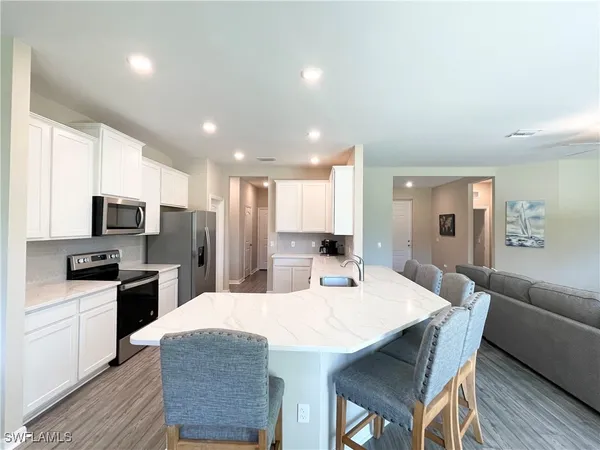 a large kitchen with kitchen island a dining table and chairs