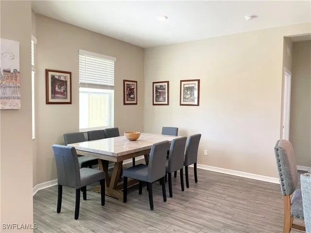 a view of a dining room with furniture and wooden floor