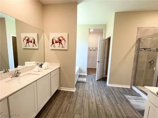 a view of a bathroom with a sink and a mirror