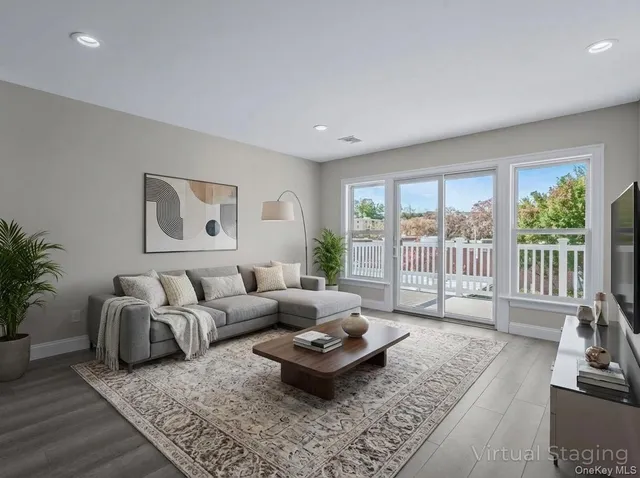a spacious bedroom with a bed a couch and a chandelier