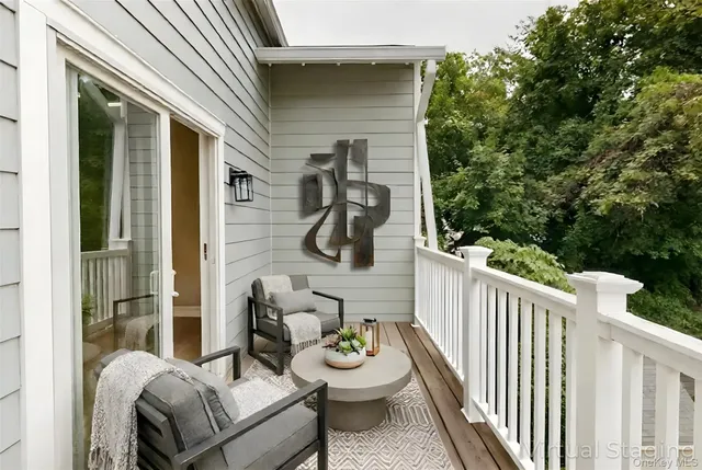 a kitchen with stainless steel appliances a sink dishwasher a stove top oven a refrigerator with white cabinets and wooden floor