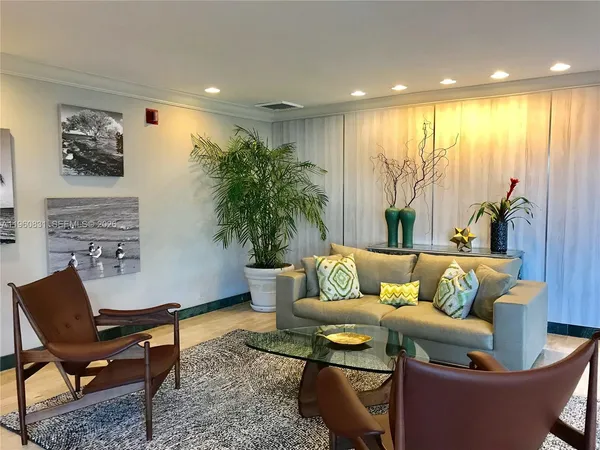 a work room with furniture and floor to ceiling window