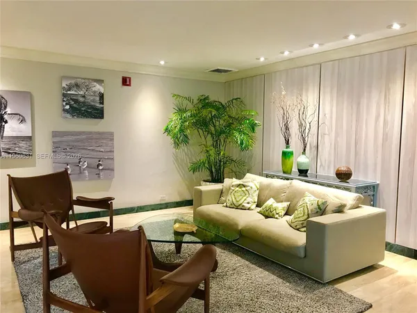 a living room with furniture and a potted plant