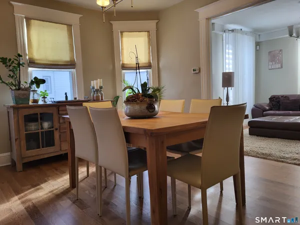 a view of a dining room with furniture and wooden floor