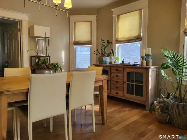 a view of a dining room with furniture and a potted plant