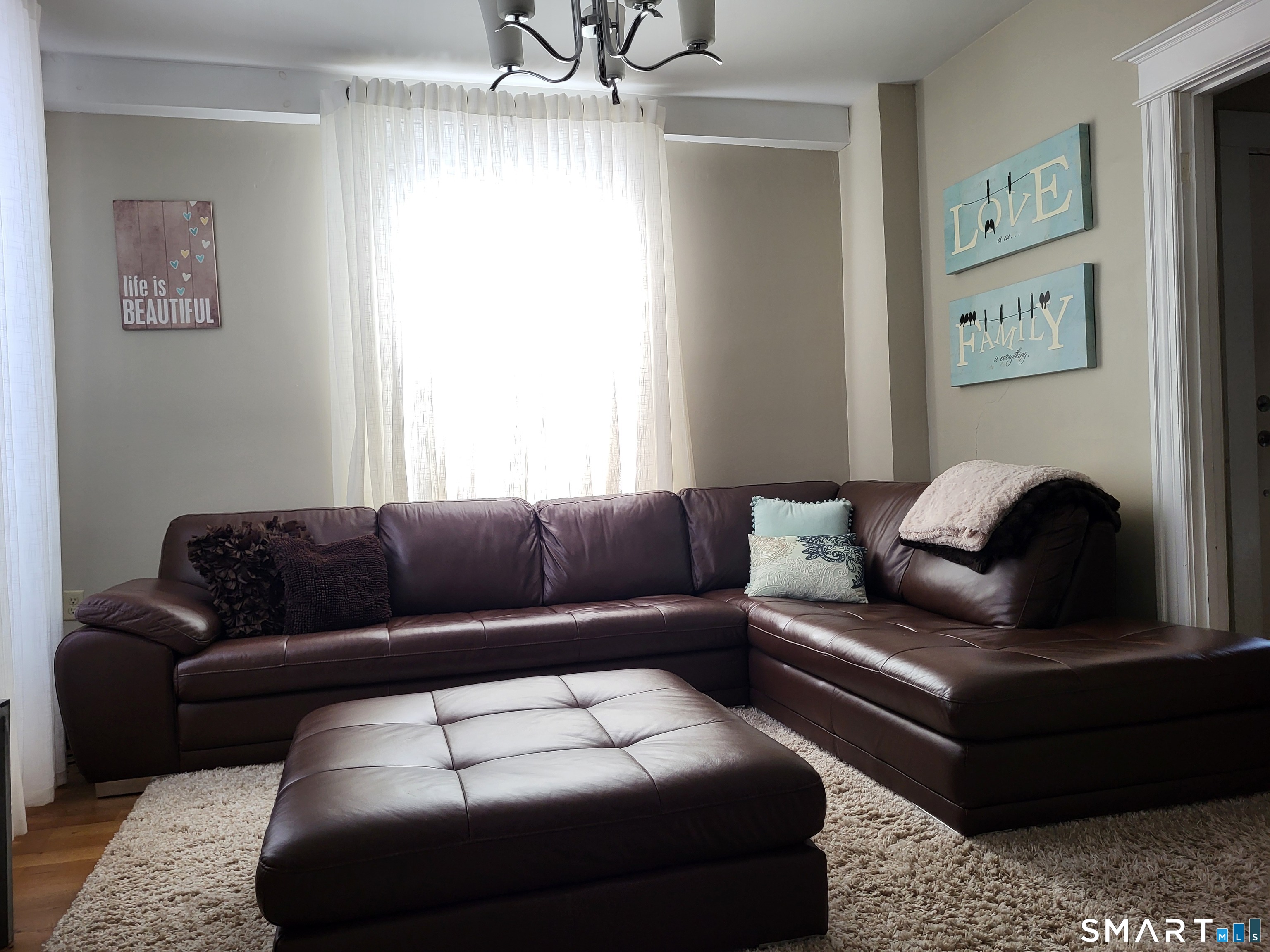110 Darby Street Bloomfield, CT 06002 - Photo 16 of 39 a living room with furniture and a couch