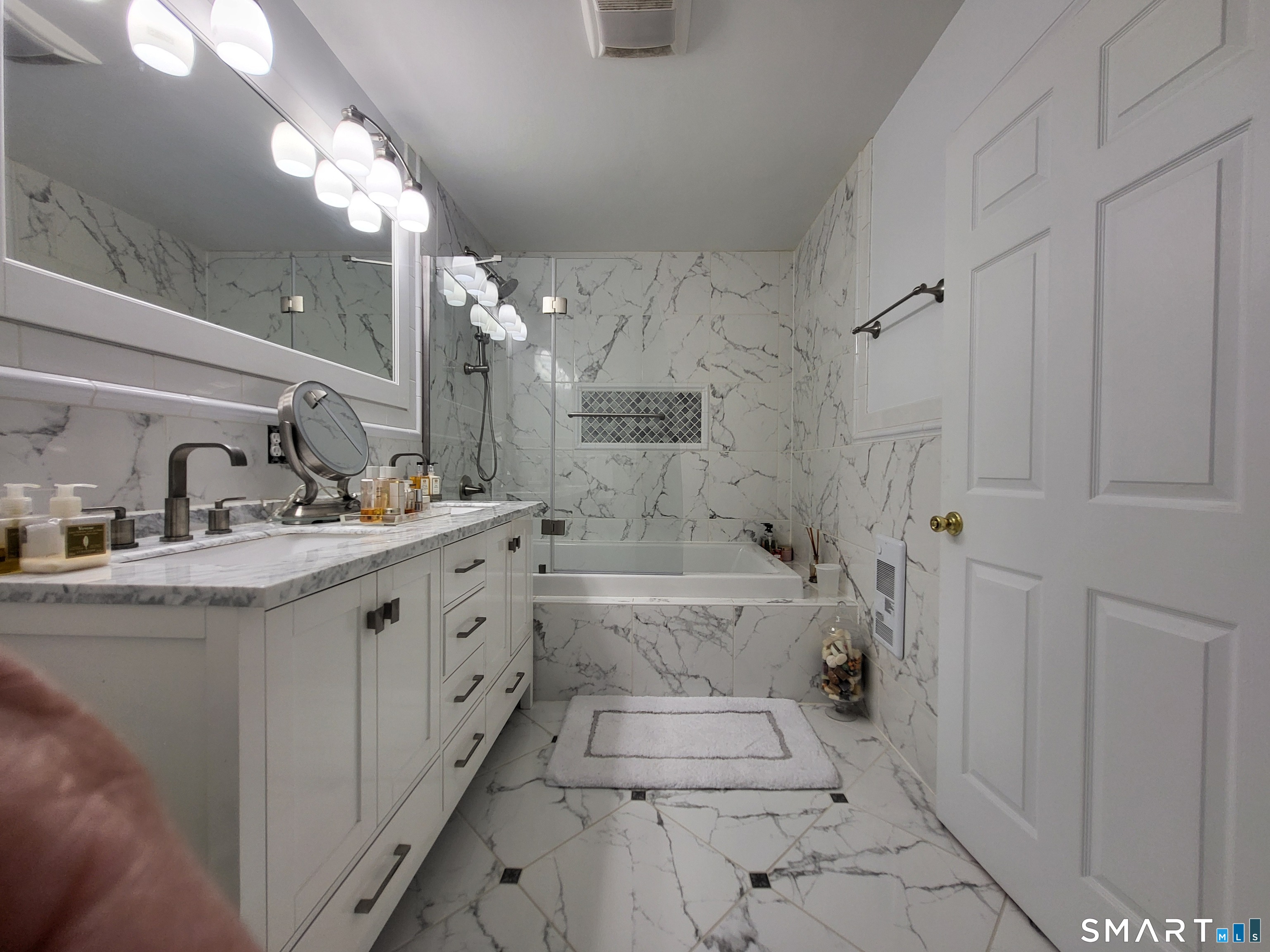110 Darby Street Bloomfield, CT 06002 - Photo 22 of 39 a bathroom with a double vanity sink a toilet a mirror and shower