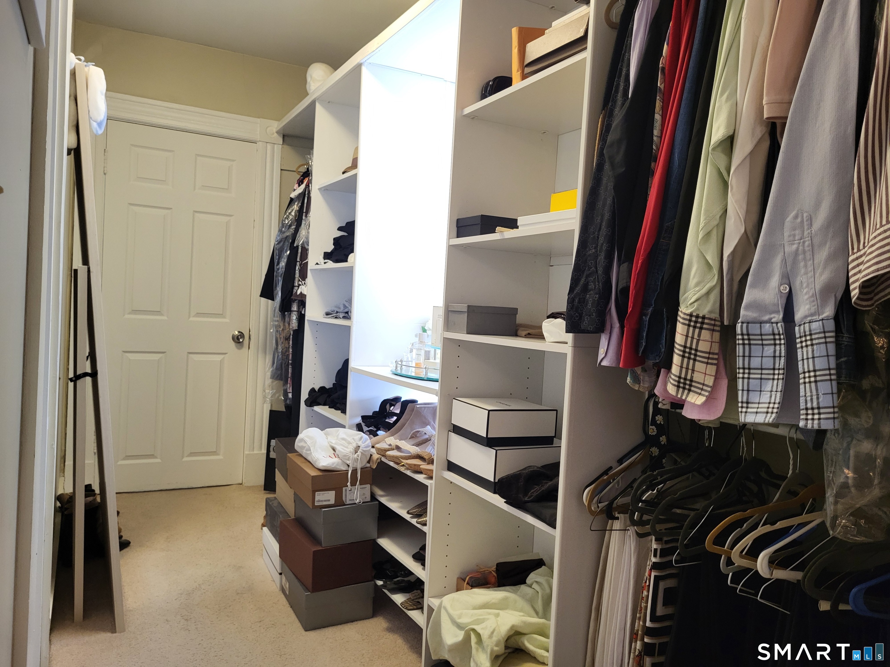 110 Darby Street Bloomfield, CT 06002 - Photo 23 of 39 a view of walk in closet with clothes and shoes