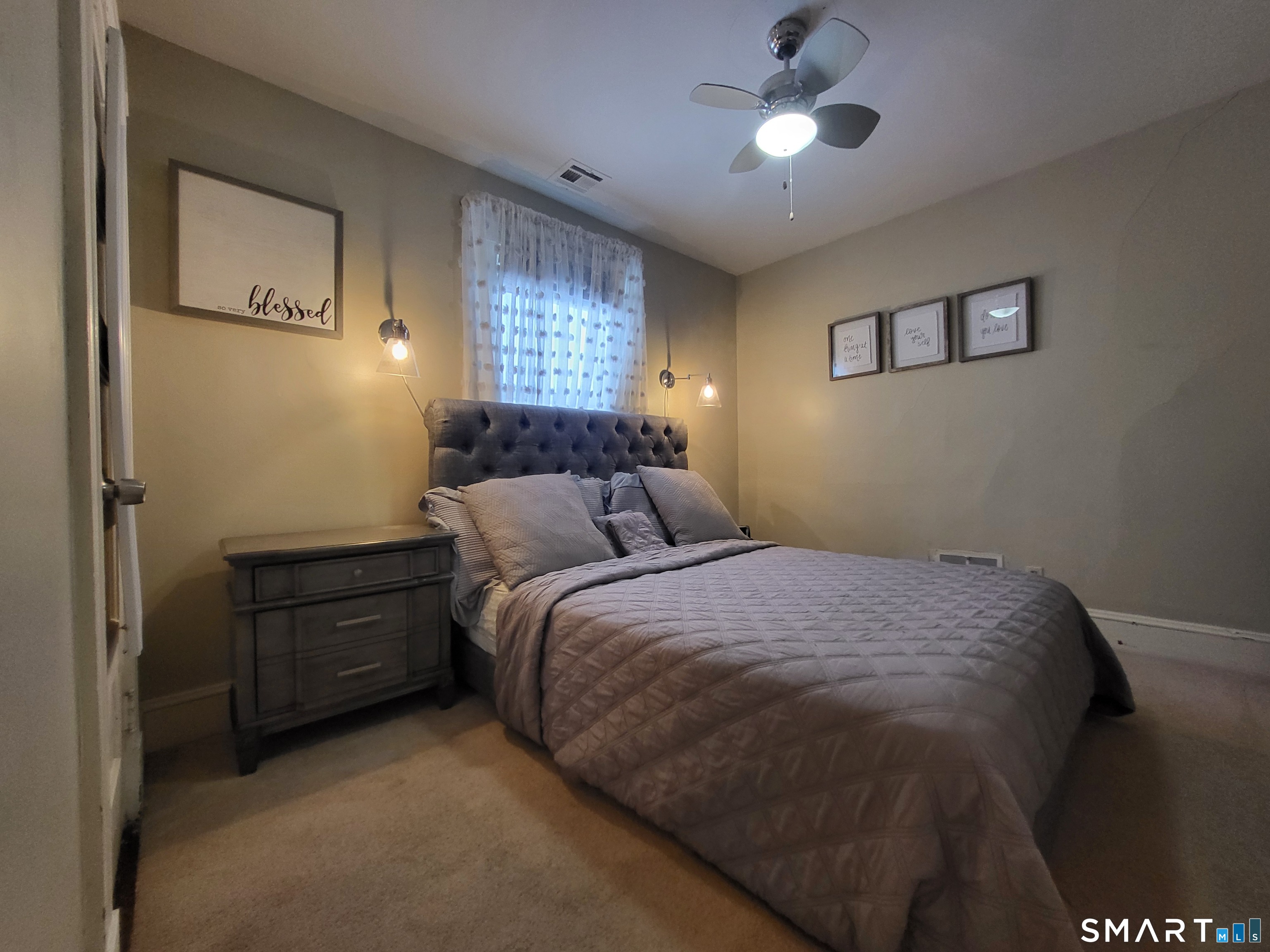 110 Darby Street Bloomfield, CT 06002 - Photo 24 of 39 a bedroom with a bed and a lamp on dresser
