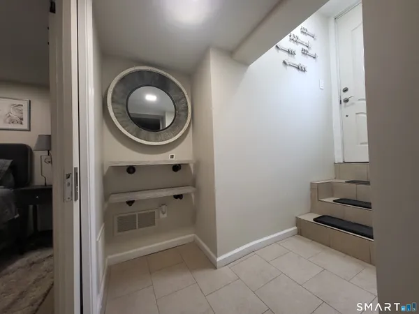 a view of a patio with table and chairs under an umbrella with wooden fence