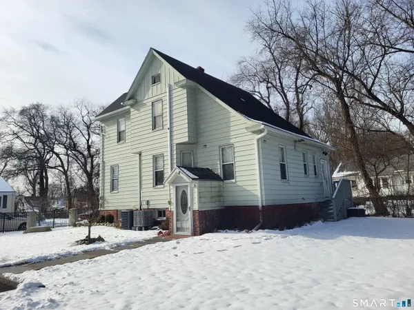 a view of a brick house with iron fence